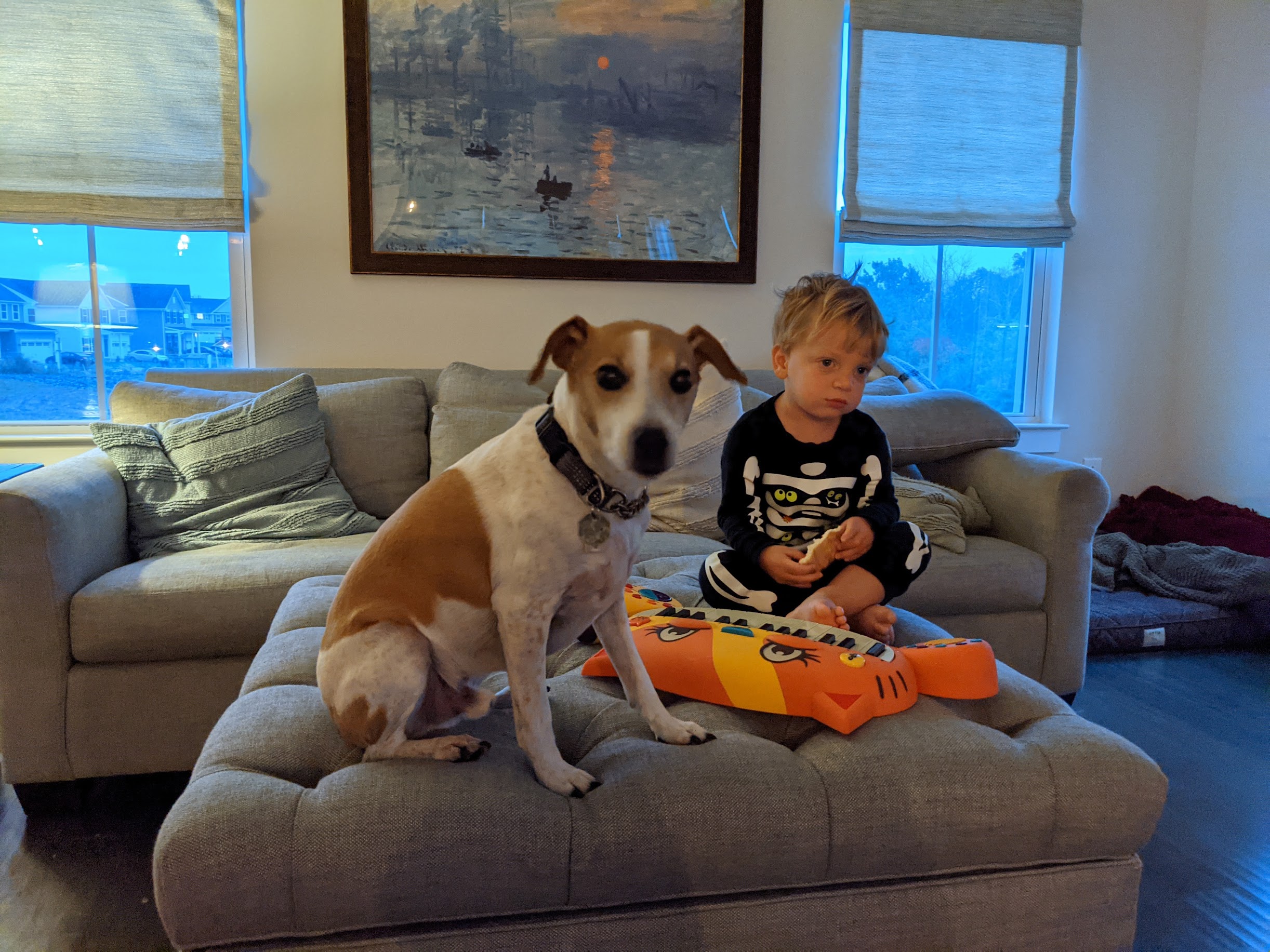 Seymour and a child sitting together on an ottoman